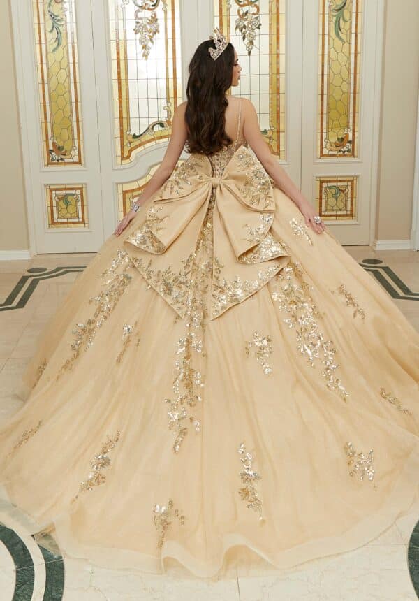 the back of a gold quince gown with a bow