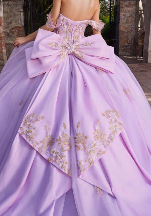the back of a purple quince dress with a bow