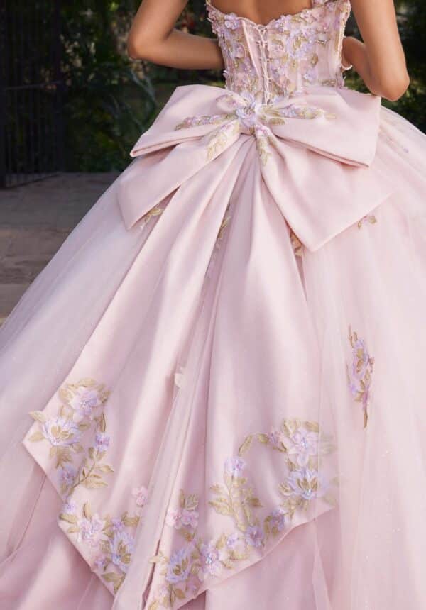 a pink bow on a quinceanera gown